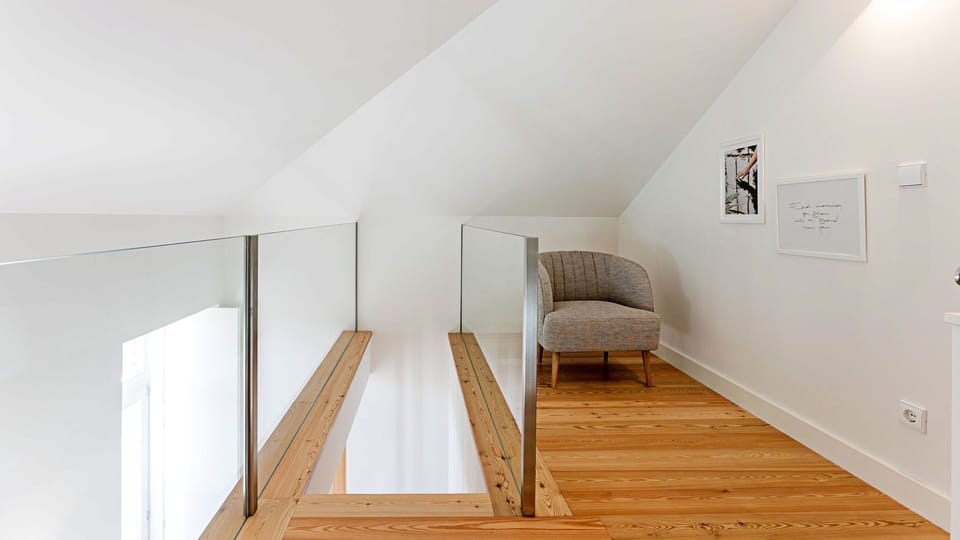 Discover a serene and quiet nook perfect for focused work or a peaceful read, offering a comfortable armchair and abundant natural light in this inviting loft space. Enjoy the tranquility of your own dedicated area, designed for both productivity and rela