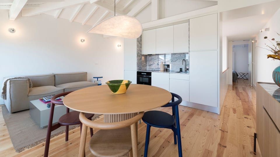 Dining area with unique furniture, next to a fully equipped kitchenette, with high-quality appliances and every supply you might need to prepare your homemade meals #superb #outstanding #lovelystay #airbnbporto