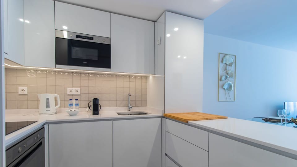 Modern kitchenette, equipped with all the utilities and essentials you might need during your stay, like a microwave, stove and oven, washing machine, dishwasher and more! #practical #nice
