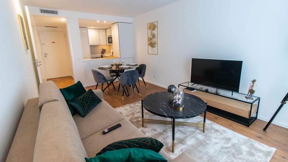 Spacious and ample living room, with a comfortable couch and dining area for four people #bright #wonderful