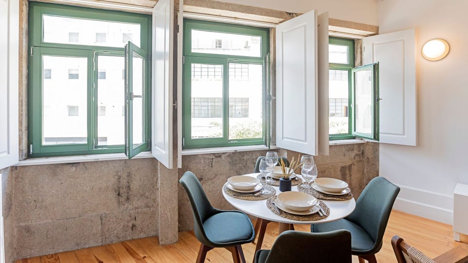 Practical dining table for four, right next to big windows that allow the entrance of lots of natural light #luminous #modern