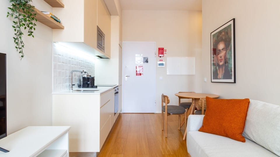 Prepare your favorite meals in this sleek, fully-equipped kitchenette, seamlessly integrated into the living space, making it easy to whip up a quick snack or a gourmet dinner. Enjoy your culinary creations at the charming dining table, perfect for shared