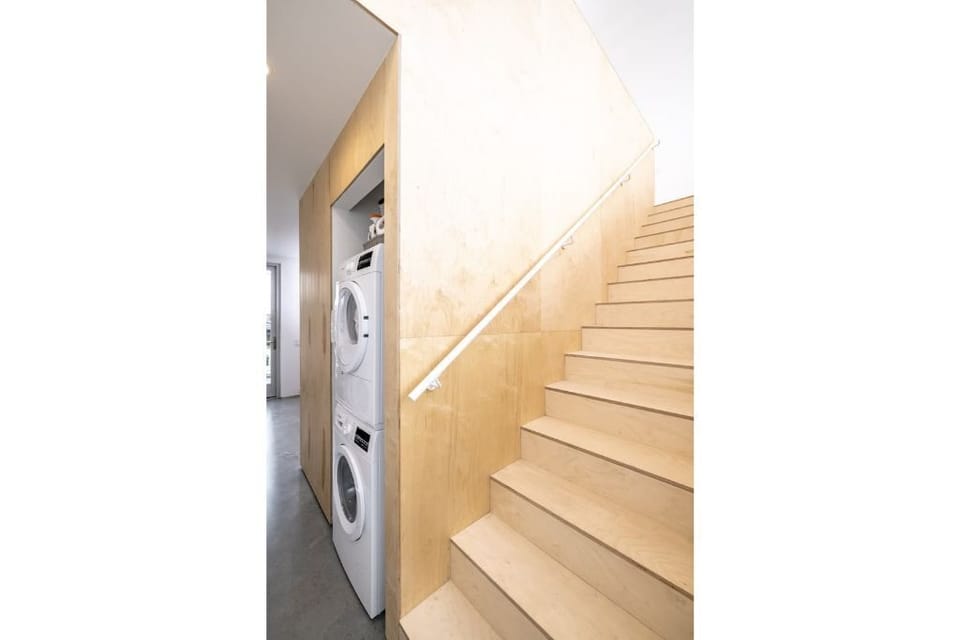 Laundry facilities and stairs to the lofted bedroom