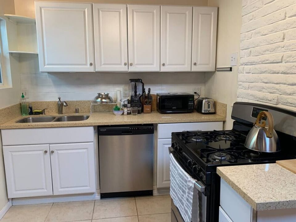 Fully equipped kitchen with pots, pans, plates, cups, etc.