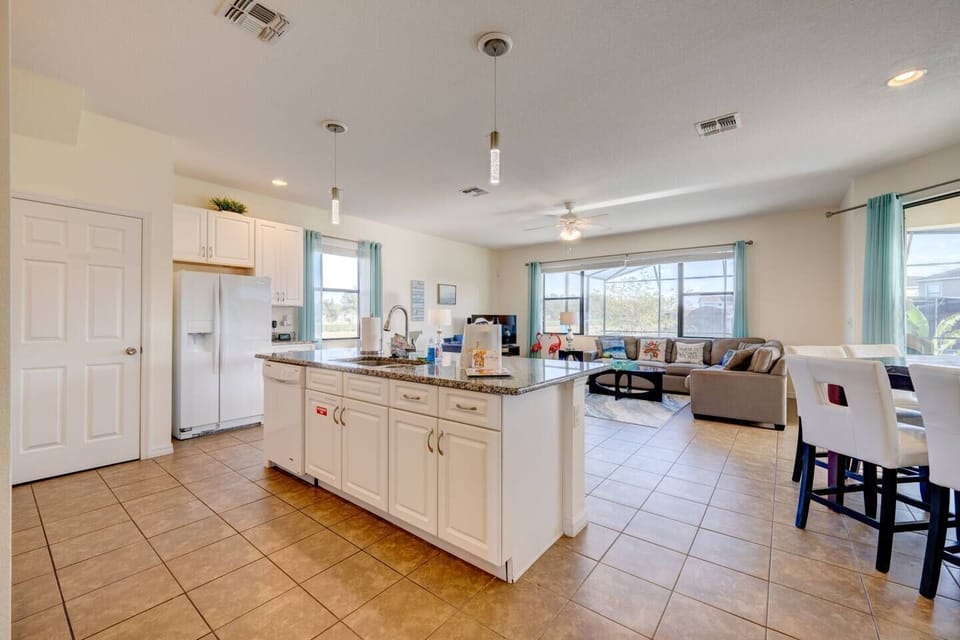 The oversized granite kitchen island is the heart of the gathering space. 
