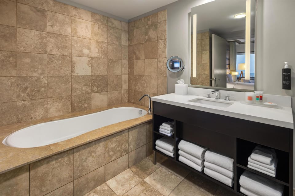 Jetted tub, rainfall showerhead, designer toiletries, hair dryer