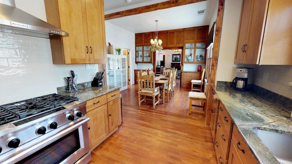 Large kitchen with view of dining and living room