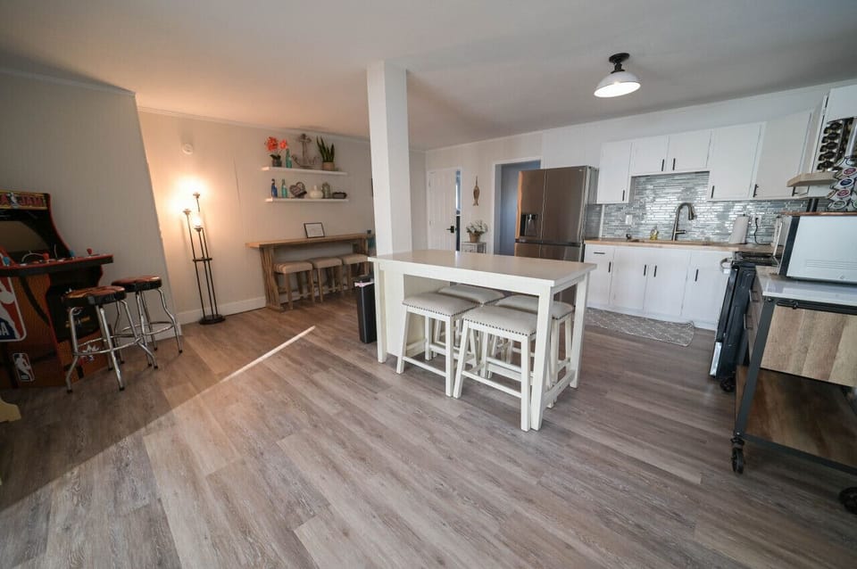 A dream kitchen with stainless steel appliances, and white cabinets, perfect for cooking and entertaining guests.