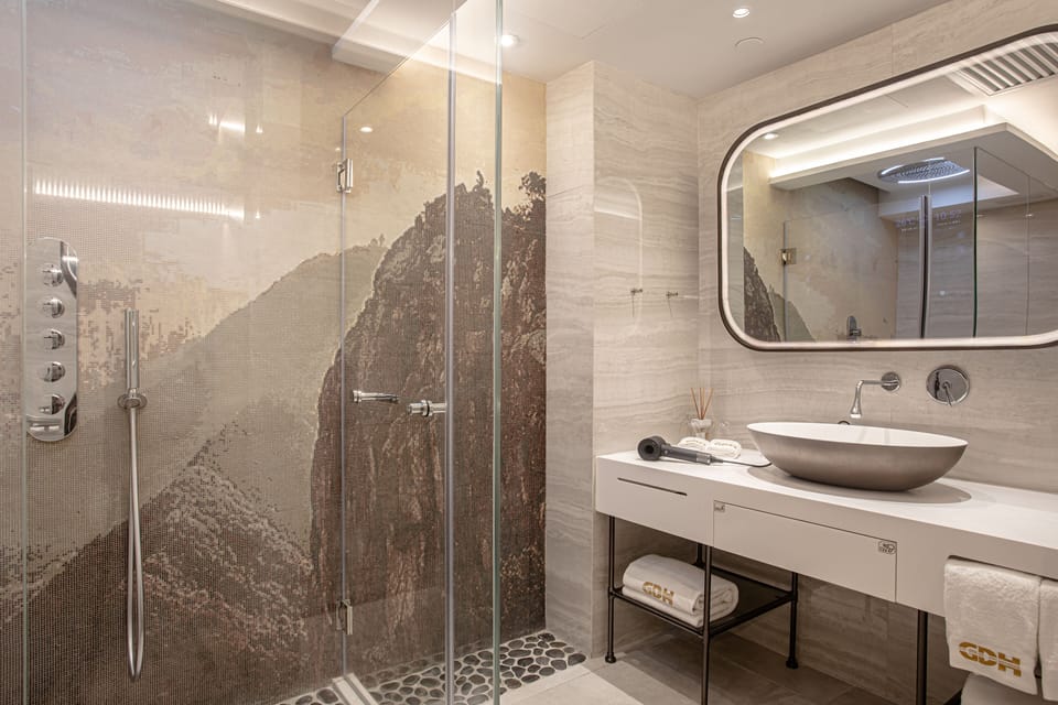 Oasis Suite | Bathroom | Shower, rainfall showerhead, hair dryer, slippers