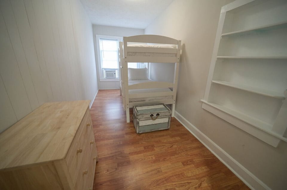 A bright and airy bedroom with a cozy bed and plenty of natural light.