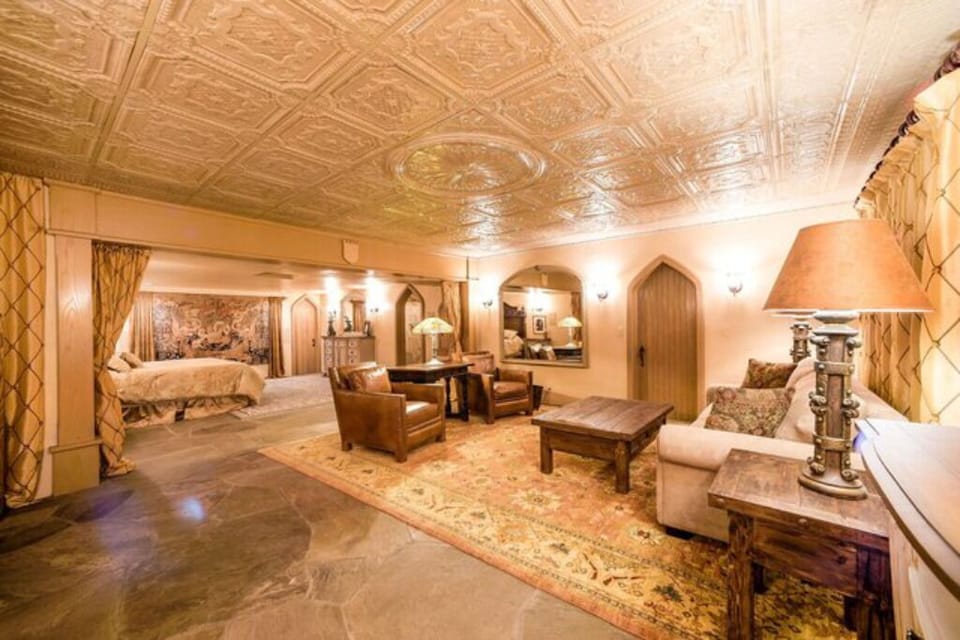 'The King's Suite' living room connects to the bedroom with a king bed