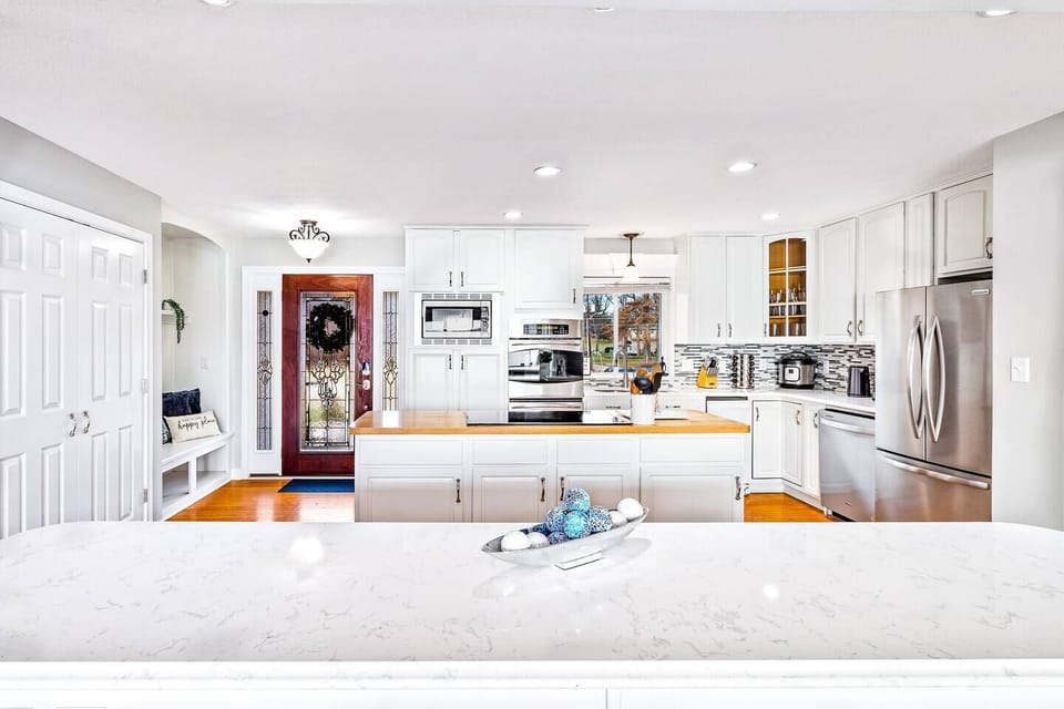 State-of-the-art open layout kitchen with all stainless steel appliances including an oven, microwave, dishwasher, duo instapot with airfryer, and tones of pots pans, cookware, bakeware & dinnerware.