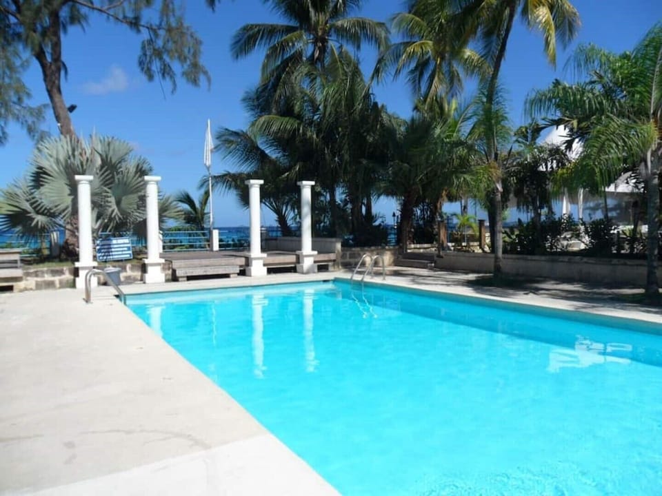pool area  with shower, changing room, bar.