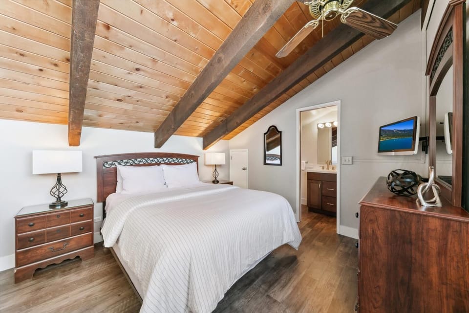 Cozy rustic bedroom with exposed beams and crisp linens creates your perfect mountain retreat sanctuary.