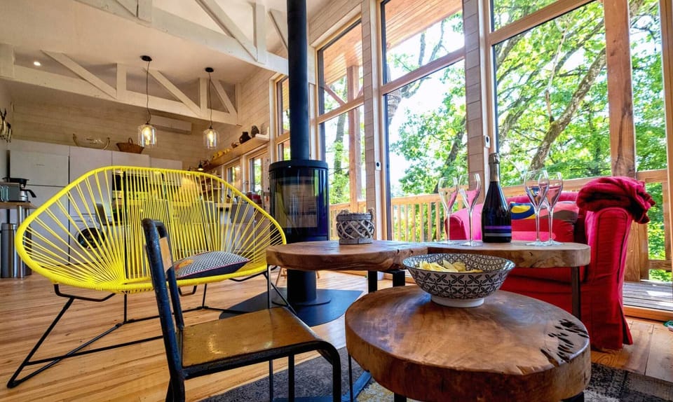 Lounge area opening onto the kitchen and dining area - Sofa bed - Armchairs - TV - Wood-burning stove (wood provided) - Board games + Books.