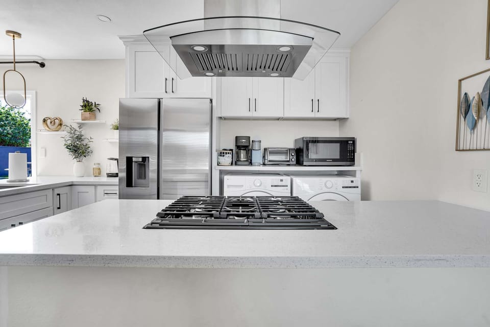 A fully stocked kitchen with a stainless steel stove.