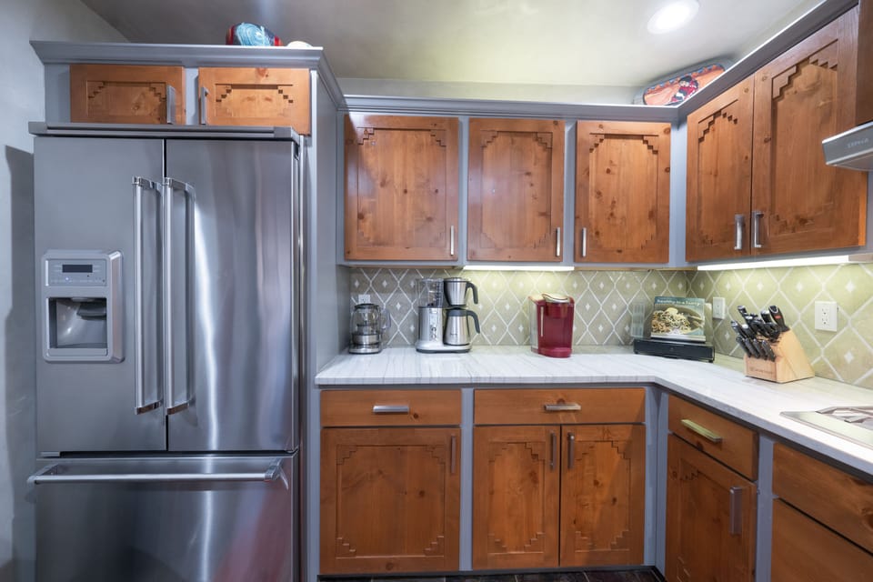 A kitchen with wood cabinets and stainless steel appliances.