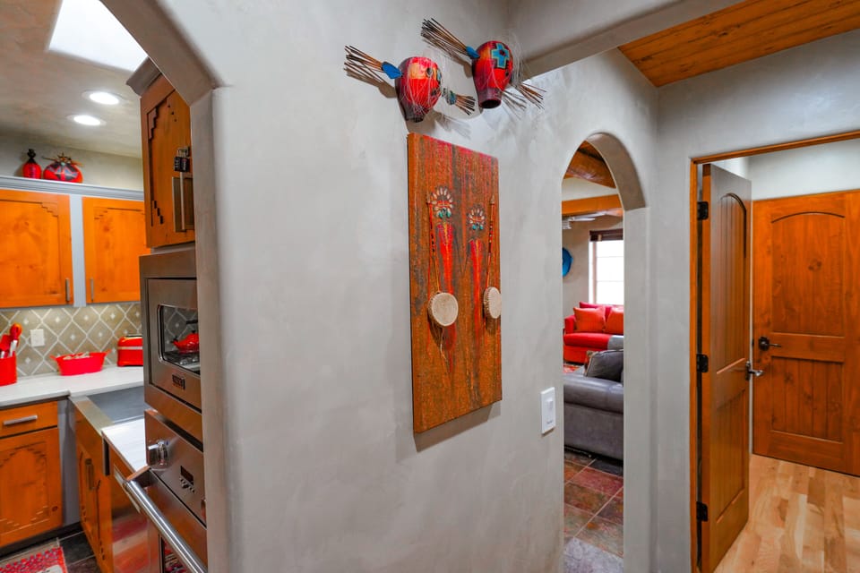 A kitchen with wooden cabinets and a wooden floor.