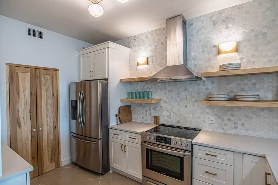 Kitchen with a full pantry and full-size washer and dryer combo.
