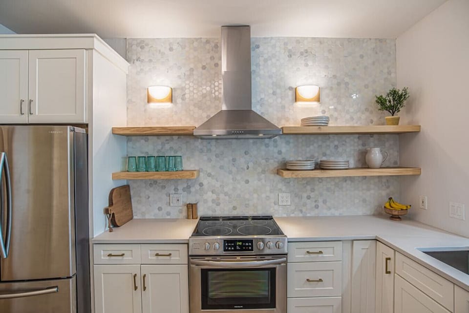 Kitchen with a full pantry and full-size washer and dryer combo.