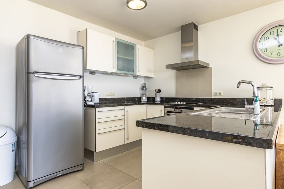 Fully equipped kitchen with oven, stove top, micro wave and refrigerator