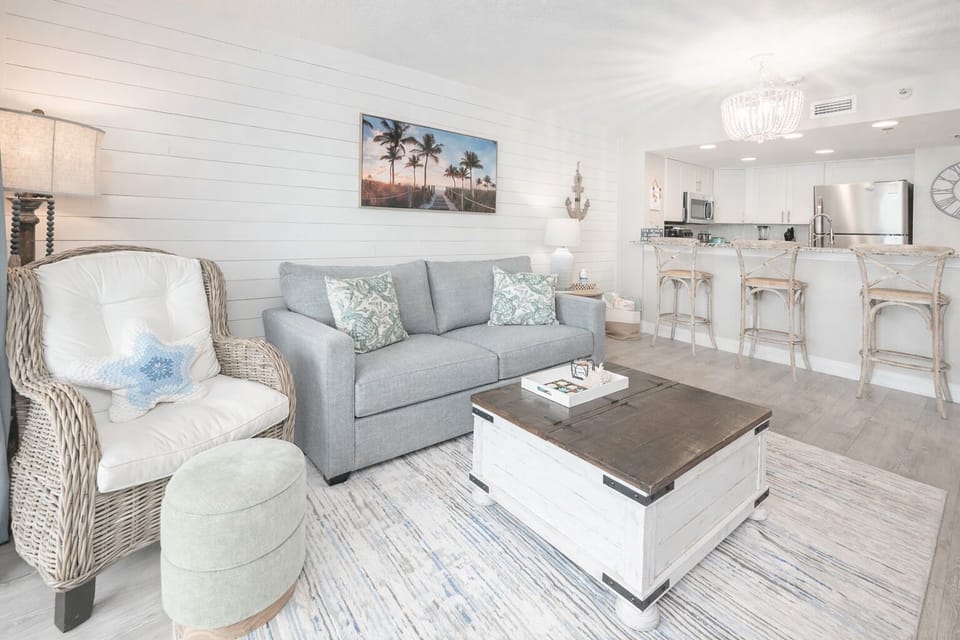 Bright coastal living room with stylish kitchen and breakfast bar