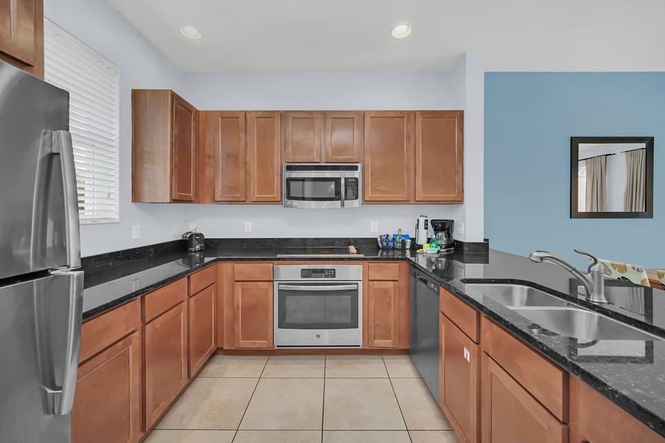 Kitchen with stainless appliances and solid surface countertops.