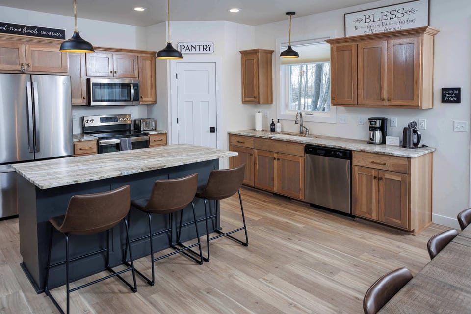 Large kitchen is fully stocked and includes seating at the island