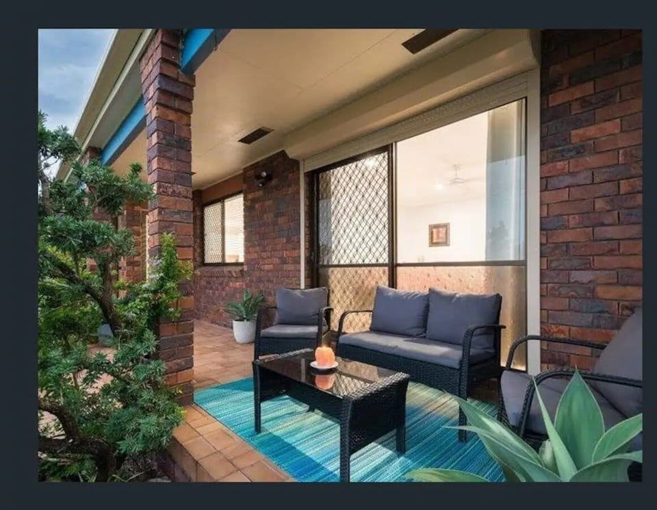 Fully fenced front yard with small patio, great for watching sunsets.