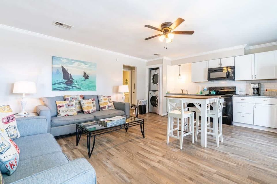Aesthetically decorated living room. Top floor, with over looking balcony, connected to a full kitchen and dining room table.