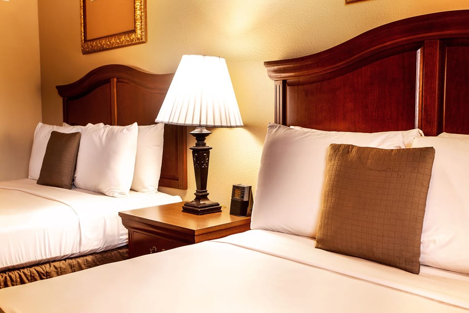 Premium bedding, desk, laptop workspace, blackout drapes