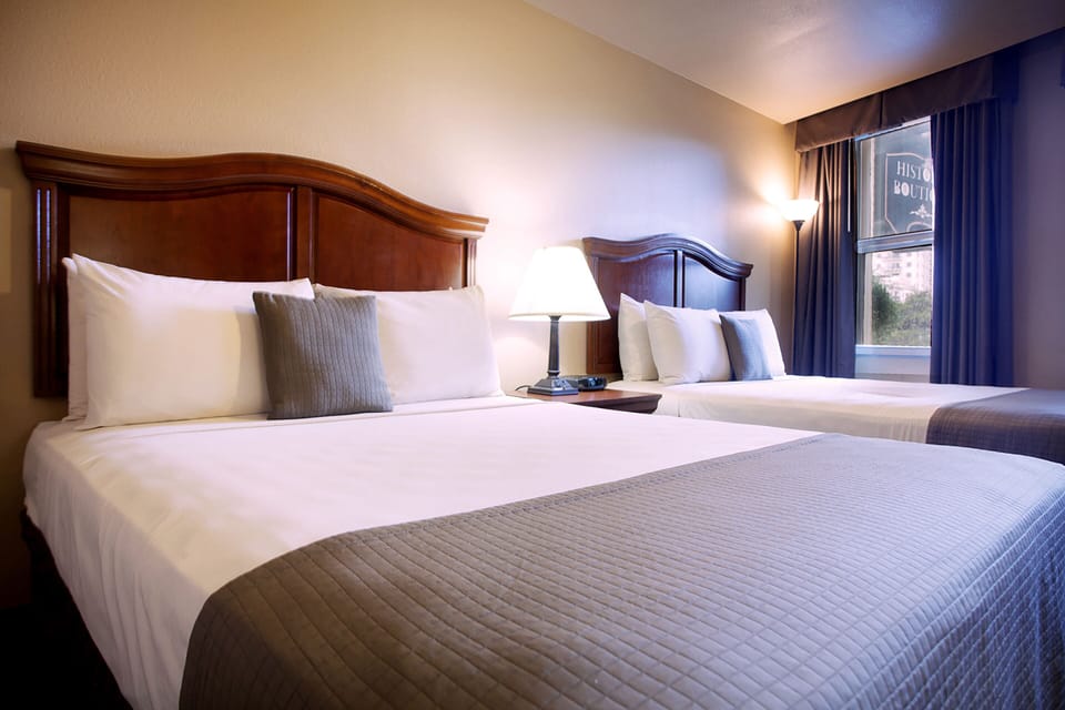 Premium bedding, desk, laptop workspace, blackout drapes