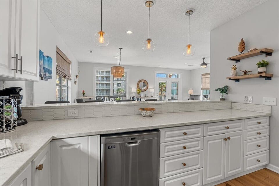 Your gourmet kitchen sparkles with granite counters, stainless appliances, and warm pendant lighting perfect for cooking memorable meals.