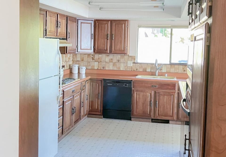 The large open kitchen even has a view of the large yard. the kitchen has a refrigerator, cook top, dishwasher, wall oven and built in microwave.