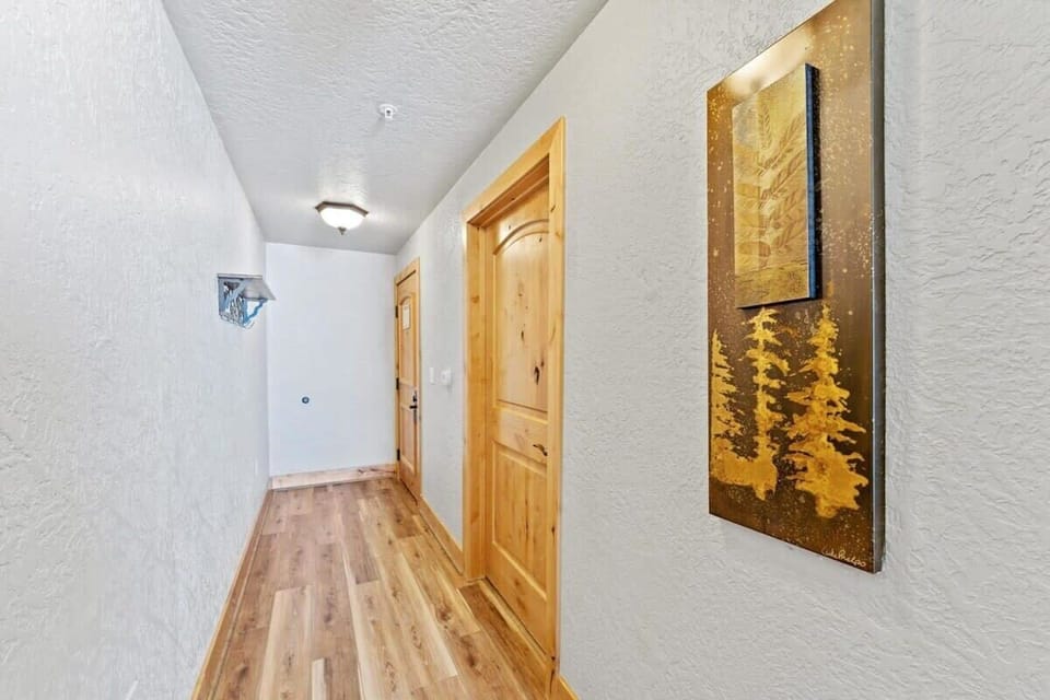 The view down the master bedroom hallway that leads to the bathroom and doorway out to the kitchen and living room.