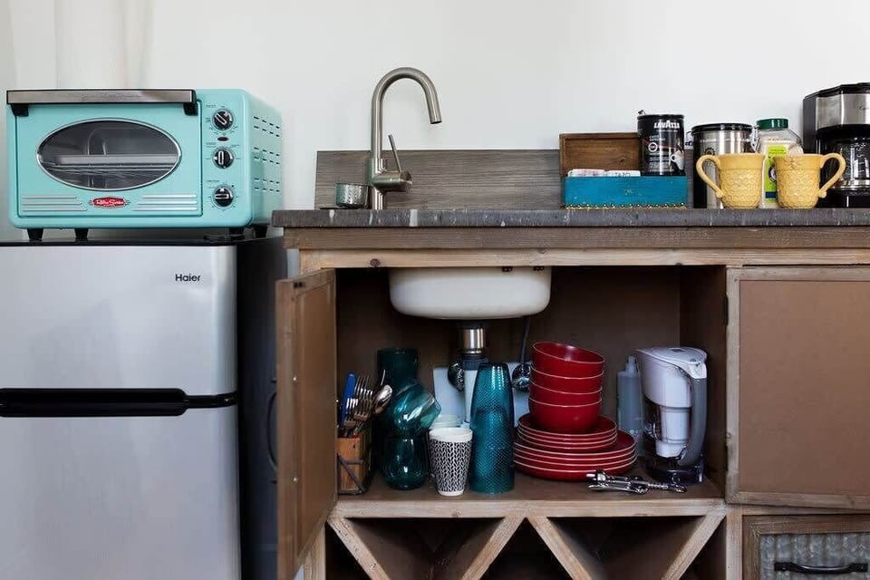 Kitchenette with tea and coffee provided. Brita water pitcher, plates, glasses, mugs, and utensils