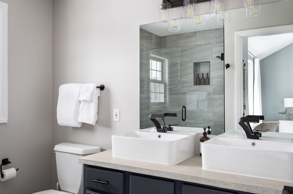 The primary ensuite bath has two spacious sinks, perfect for the busy morning rush of getting everyone out and ready to explore, party with friends or make sure your bridal group is picture-perfect on your special day.