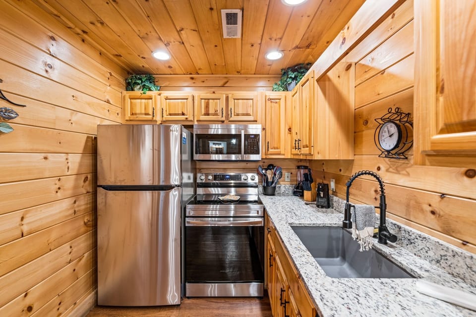 Full kitchen with coffee machine and tea kettle 