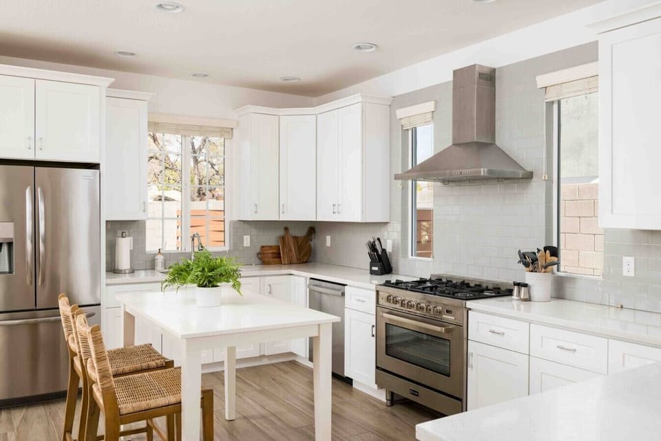 The gourmet style, eat-in kitchen features quartz countertops with stainless steel appliances, plus plenty of cookware to help you put together any meal.