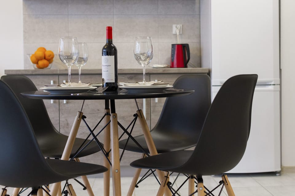 A stylish dining table with black chairs and table settings, creating a perfect spot for a cozy meal.