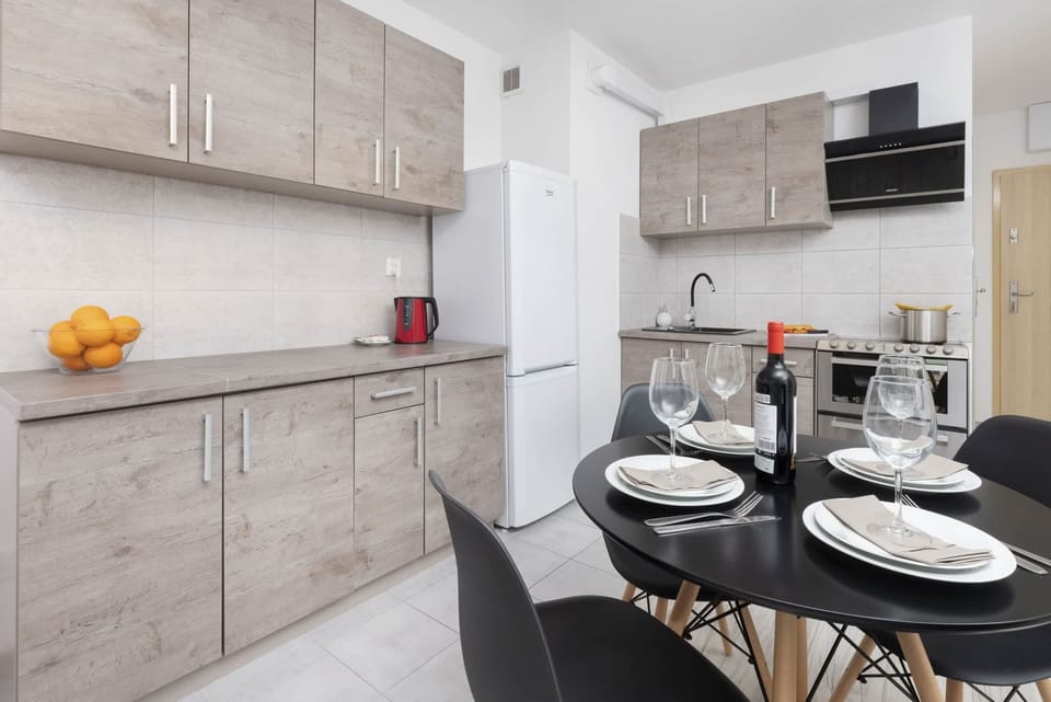 A stylish dining table with black chairs and table settings, creating a perfect spot for a cozy meal.