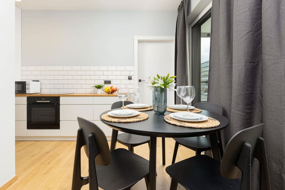 A stylish dining area with an elegant table set for four.

