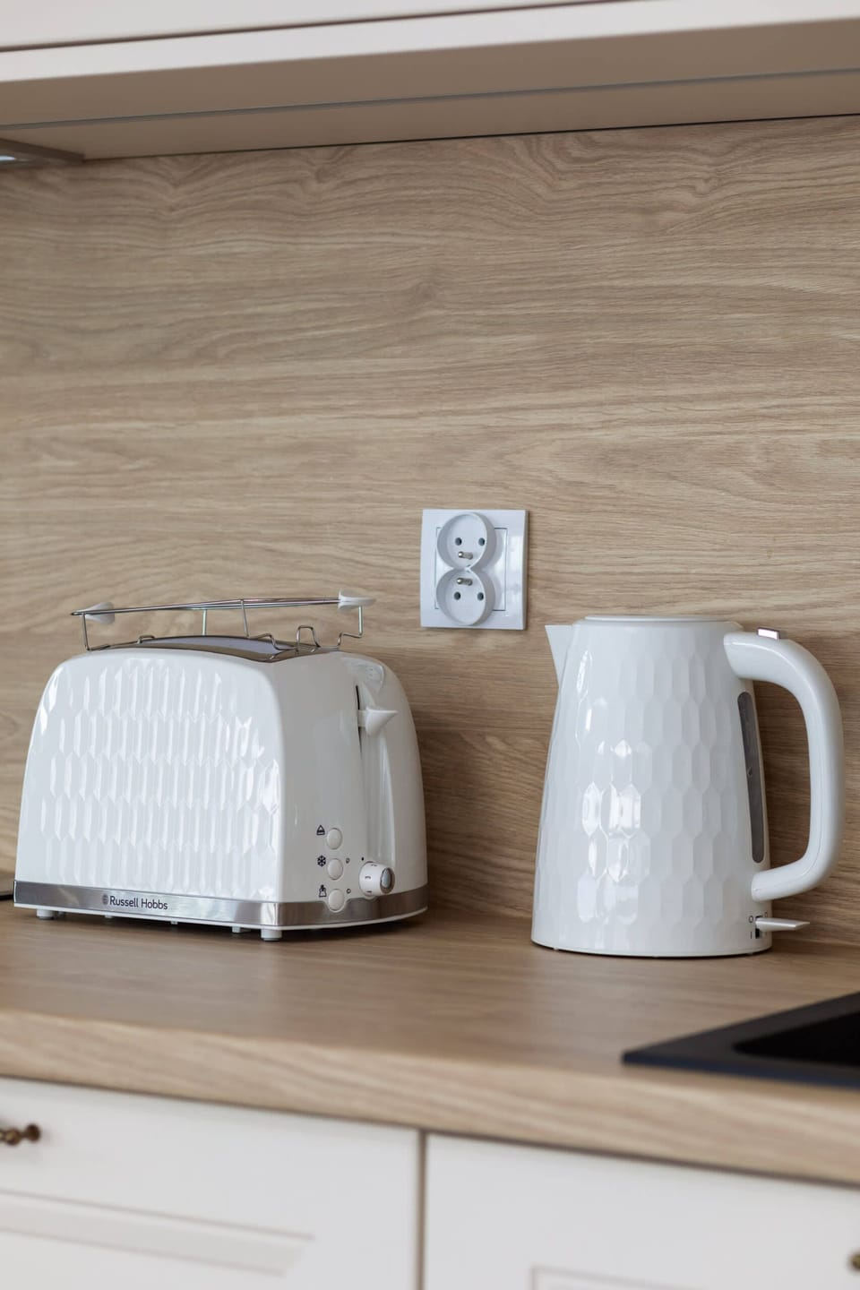 A close-up of a kitchen counter equipped with essential small appliances.

