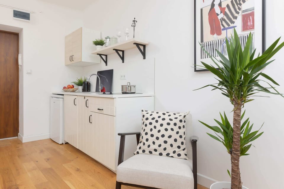 A spacious and bright living area with a dining nook and stylish furnishings.
