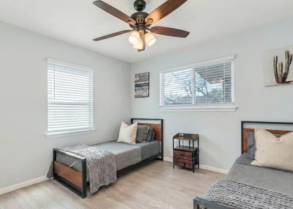 Bedroom features two single beds. Please note that decorative pillows and throws are for staging purposes only and are not included.