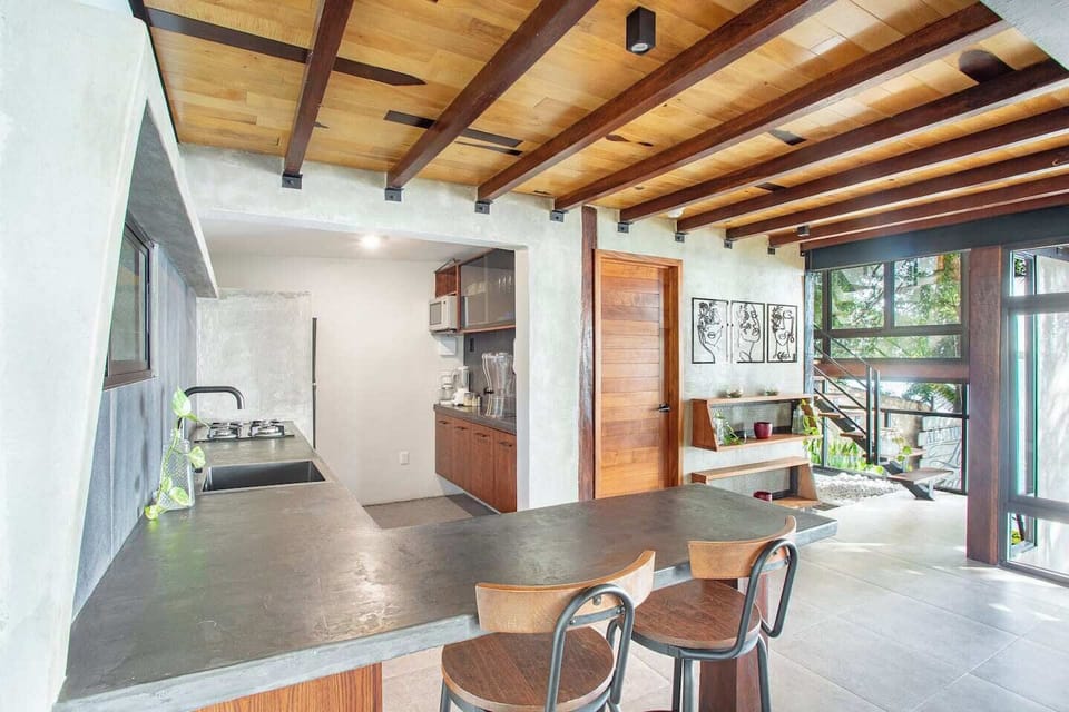 "In this image, you can see our cozy kitchen, fully equipped for you to enjoy a relaxing getaway. Its location creates an ideal atmosphere for family togetherness, always featuring the beautiful view of Bacalar Lagoon as a backdrop."