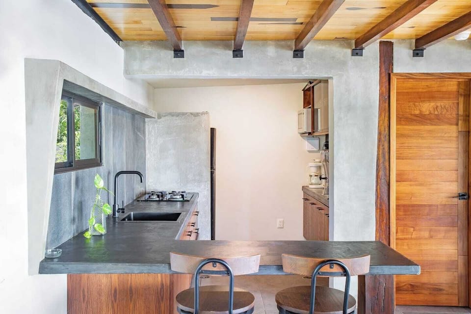 "In this image, you can see our cozy kitchen, fully equipped for you to enjoy a relaxing getaway. Its location creates an ideal atmosphere for family togetherness, always featuring the beautiful view of Bacalar Lagoon as a backdrop."
