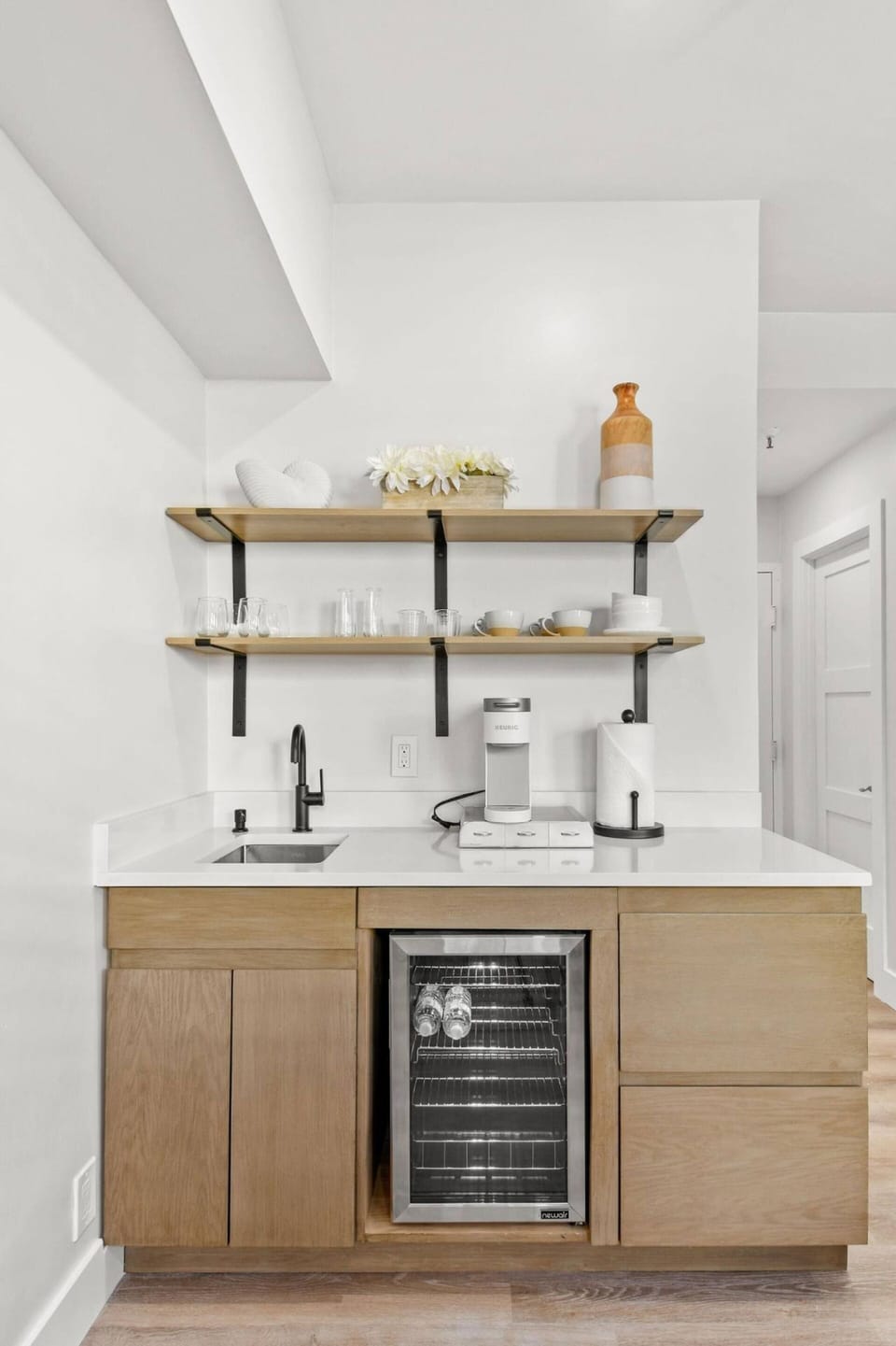 Fully stocked kitchenette with glasses, plates, and cutlery
