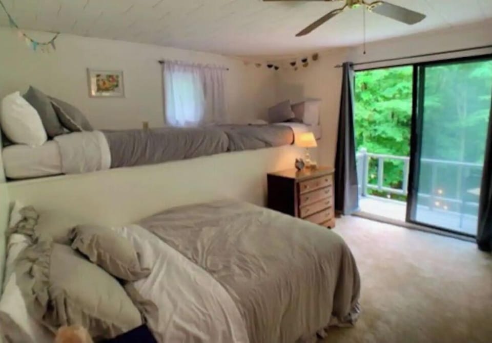 This bedroom has a full and two twin beds. Along with a small balcony.