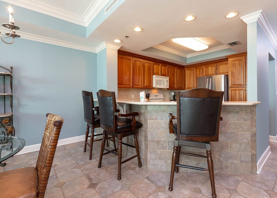 Gather around the stylish bar seating for casual meals, with the kitchen just steps away for easy dining